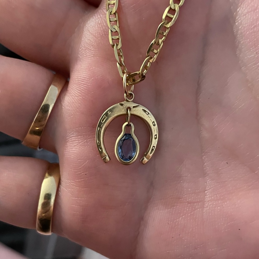 14K horseshoe charm with blue topaz